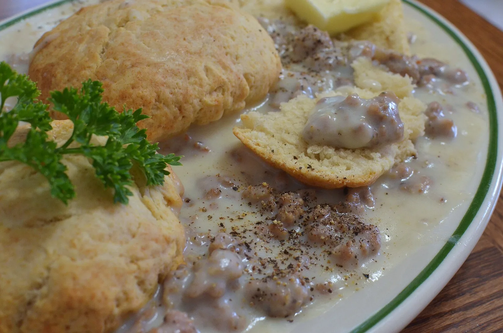 Biscuits with sausage gravy and butter on a diner plate. The photo was not taken at a Wilmington restaurant.