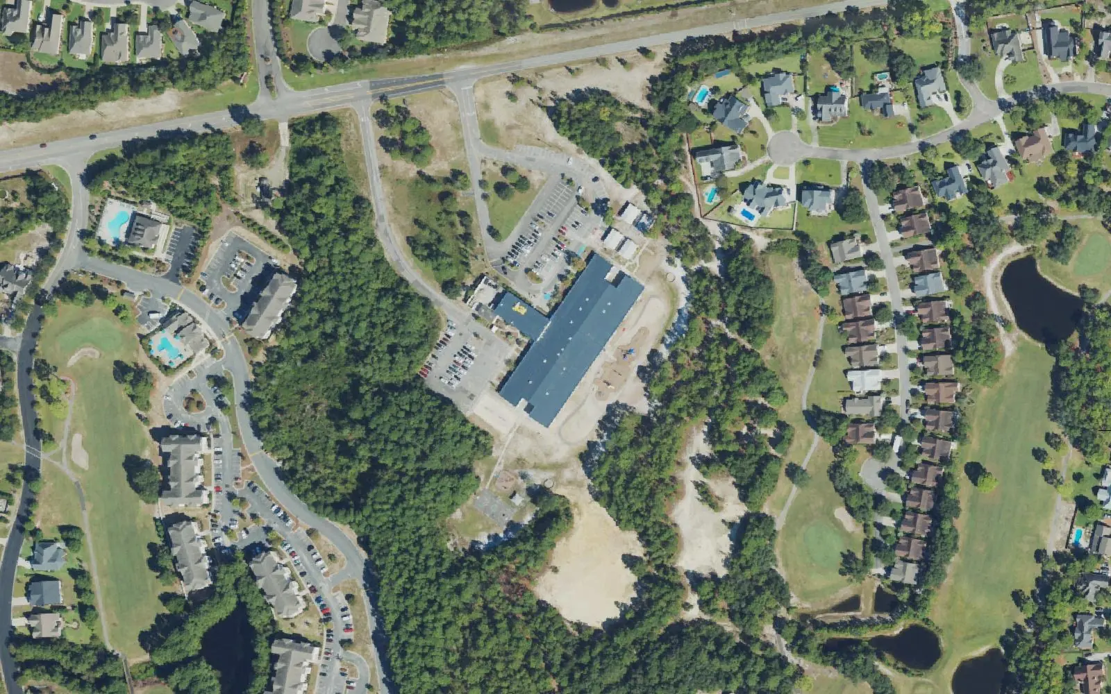 Heyward C. Bellamy Elementary School off Sanders Road, south of Wilmington, seen from the air, with apartments and a golf course around it