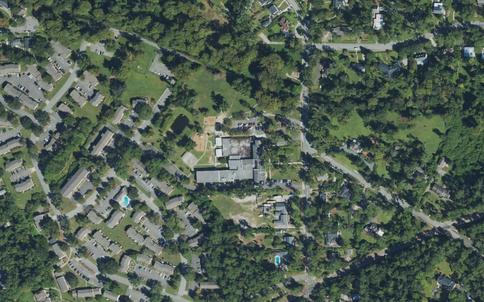 Forest Hills Global Elementary School among the trees and homes of Wilmington's Forest Hills neighborhood, seen from the air