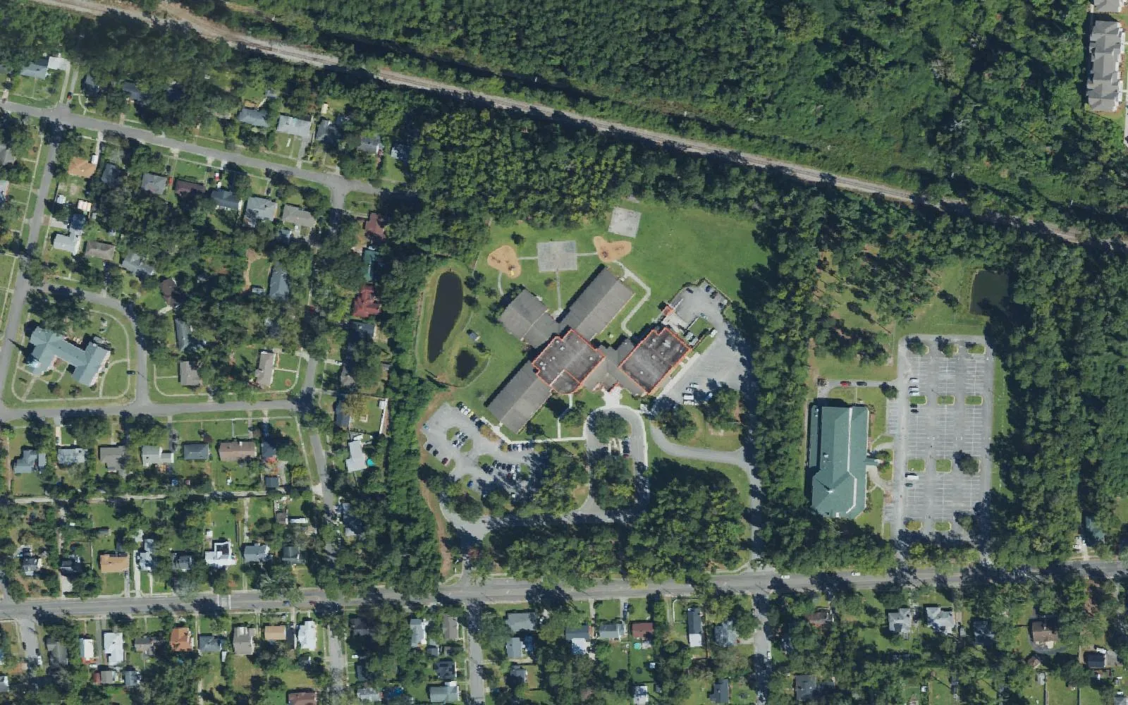 The Rachel Freeman School of Engineering campus off Princess Place Drive in Wilmington, seen from the air, with its pond and playground to the west
