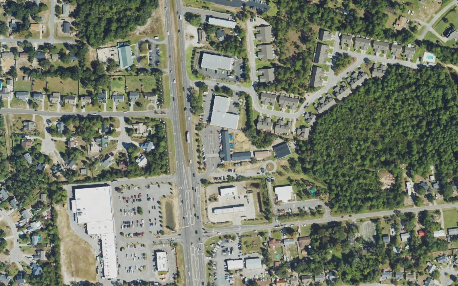 Carolina Beach Road and the shopping centers and neighborhoods around Island Montessori Charter School, south of Wilmington, seen from the air