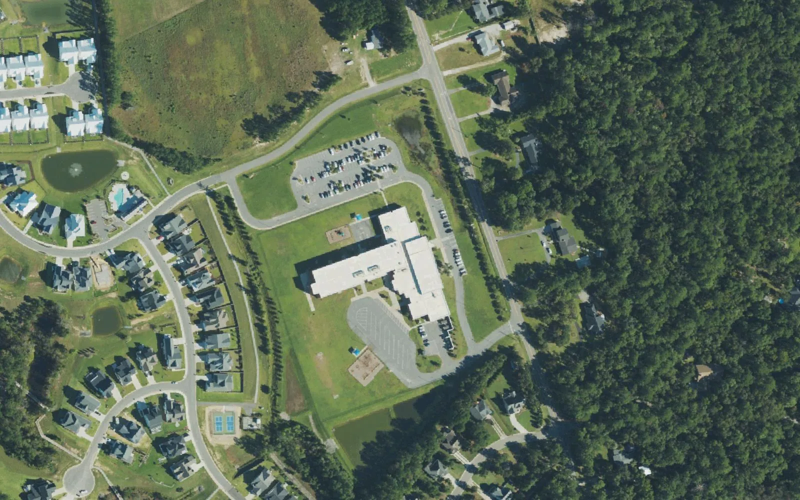 Porters Neck Elementary School off Edgewater Club Road, seen from the air, with new homes to the west and woods to the east