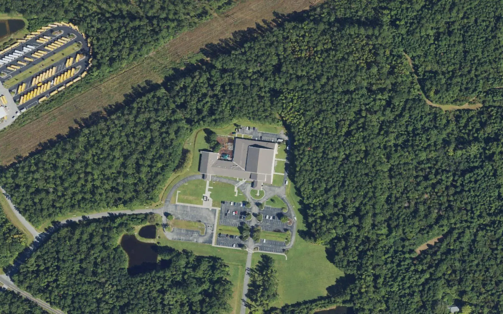 Southeast Area Technical High School's building and parking lots in the woods off Sidbury Road in Castle Hayne, seen from the air