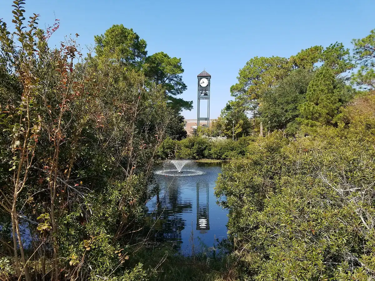 The clock tower and pond at the University of North Carolina Wilmington.